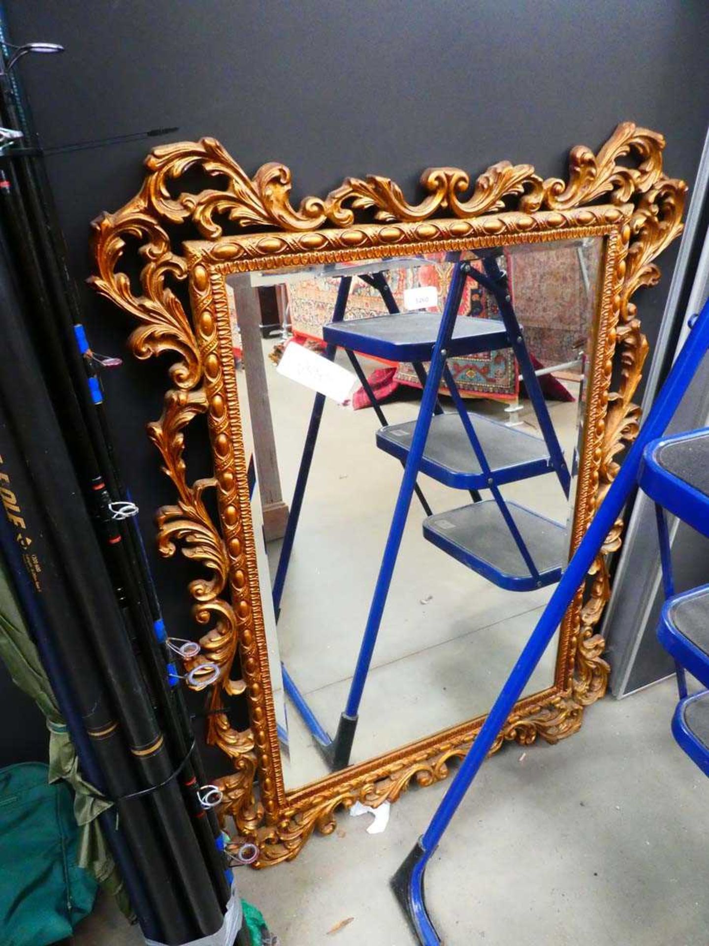 Rectangular bevelled mirror in decorative gilt frame