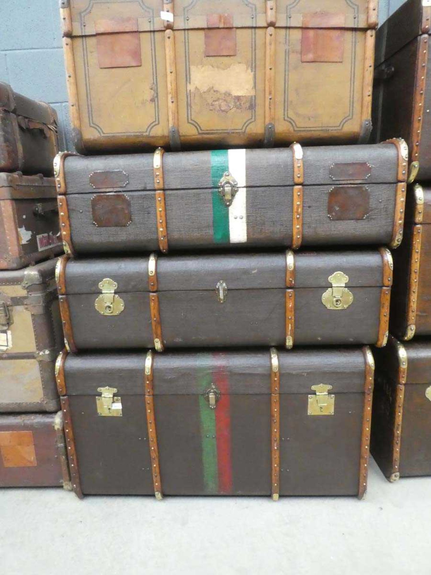 3 x slightly graduated wooden banded and painted travelling trunks, max width: 109cm