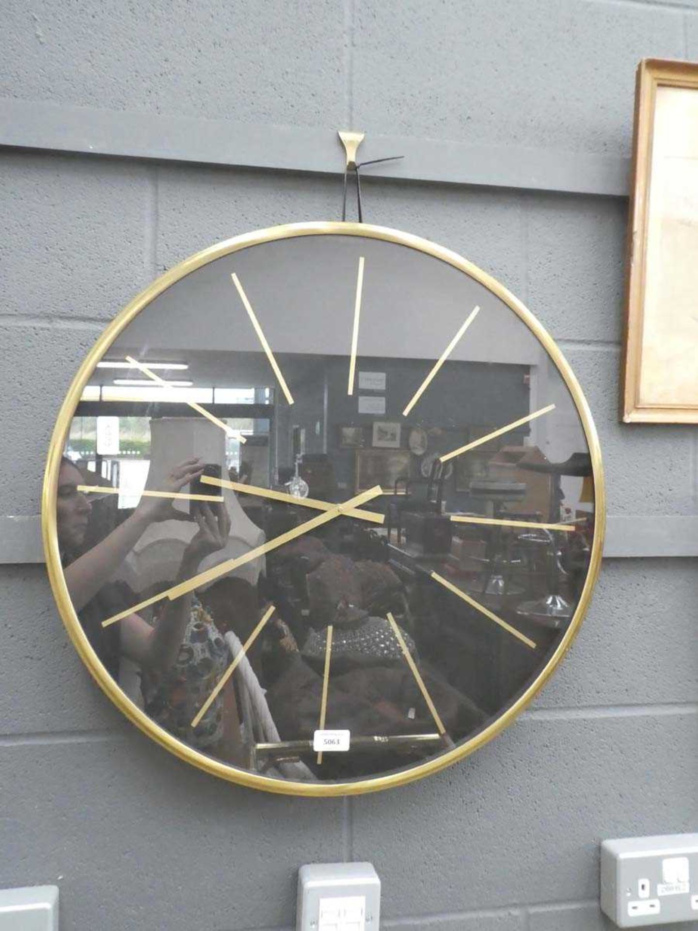 Modern black wall clock in gilt frame