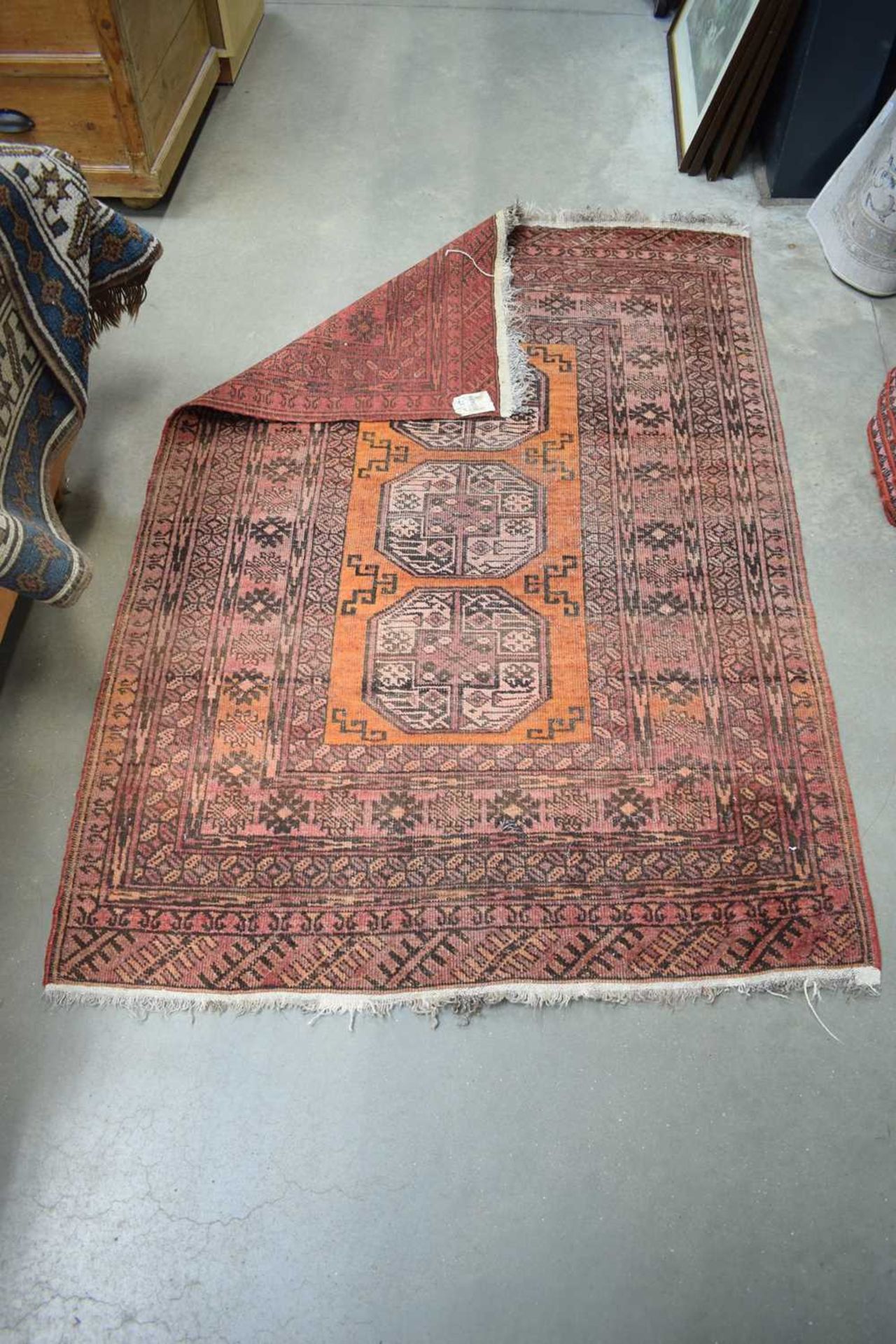 A Persian rug with three medallians, an orange ground and red bands, 156 x 106 cm