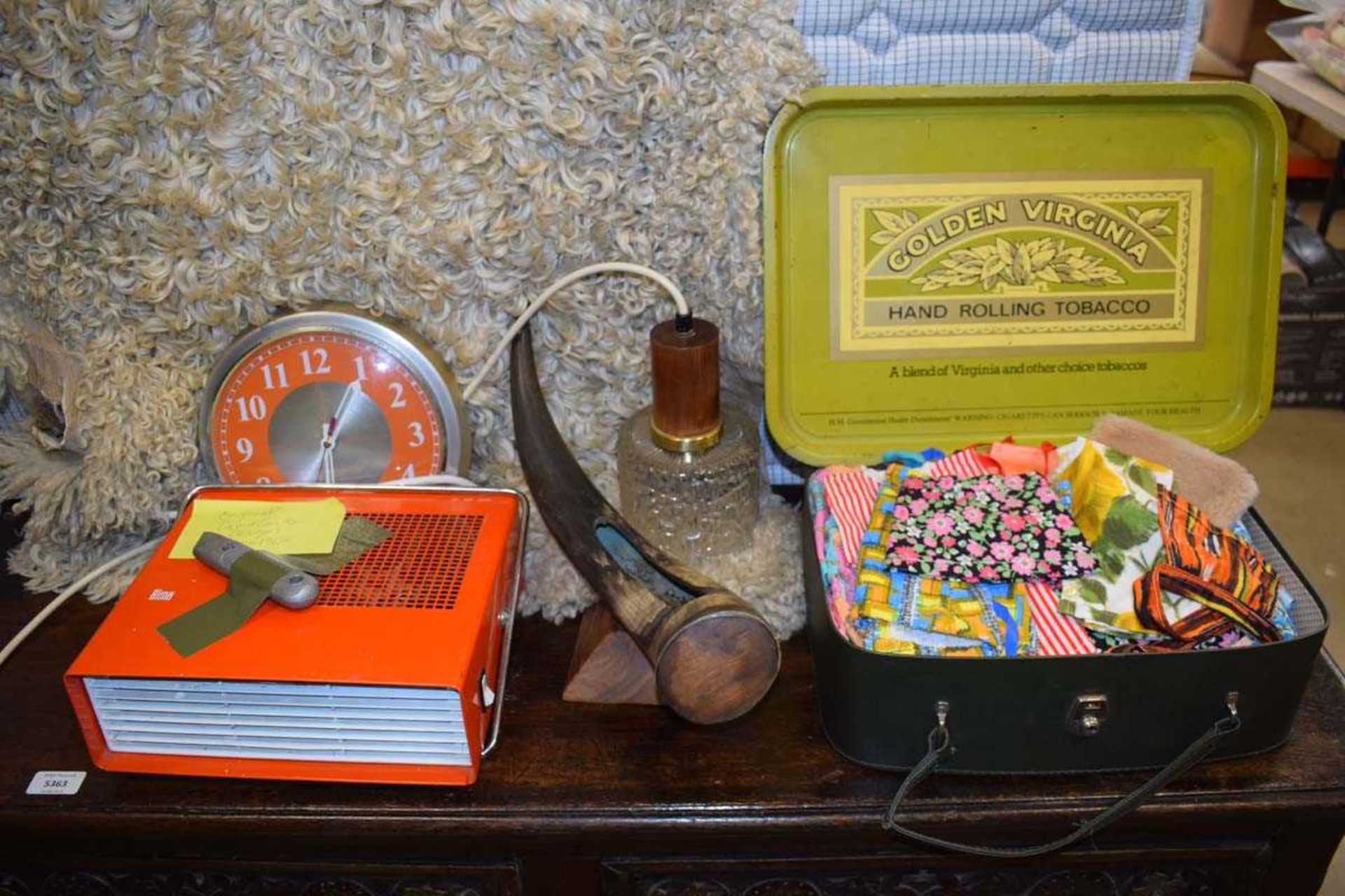 Box containing a cows horn on mount, a case of 1960's doll's clothing, a quartz clock, a David