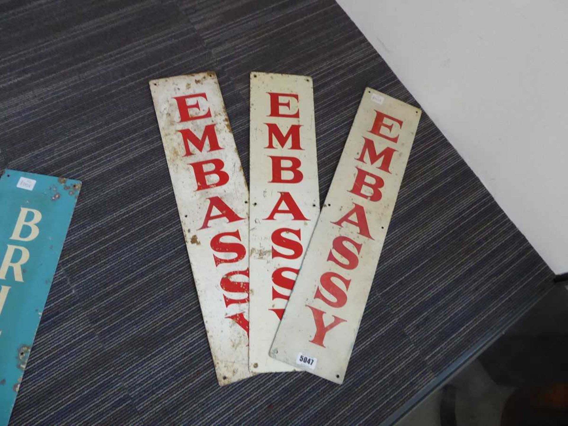 Three Embassy cigarette tin signs