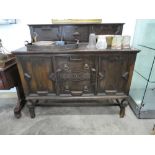 Dark oak sideboard with 2 central drawers and 2 cupboards on turned supports