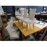 Large beech effect extending dining table with 6 similar oatmeal upholstered dining chairs