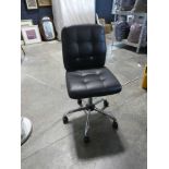 Black vinyl upholstered swivel office armchair on 5 star base