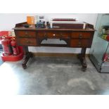 Mahogany dressing table on casters with an arrangement of 5 drawers