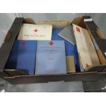 Box containing British Red Cross Society ephemera and vintage nurses uniform