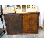 Dark stained bookcase with wooden sliding doors