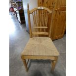 Ash framed rush seated dining chair with feather patterned back