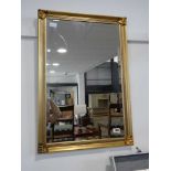 Rectangular gilt framed and beveled wall mirror