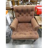 Victorian upholstered button back armchair on wooden supports and castors *Item sold subject to