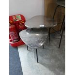 +VAT Nesting pair of silver coloured plectrum shaped tables on tripod supports