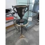 +VAT Black and gilt wine table and similar twin handled urn