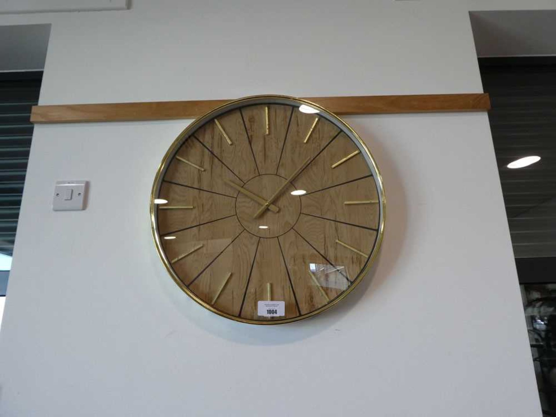 +VAT Brass coloured wall clock with pine effect backboard