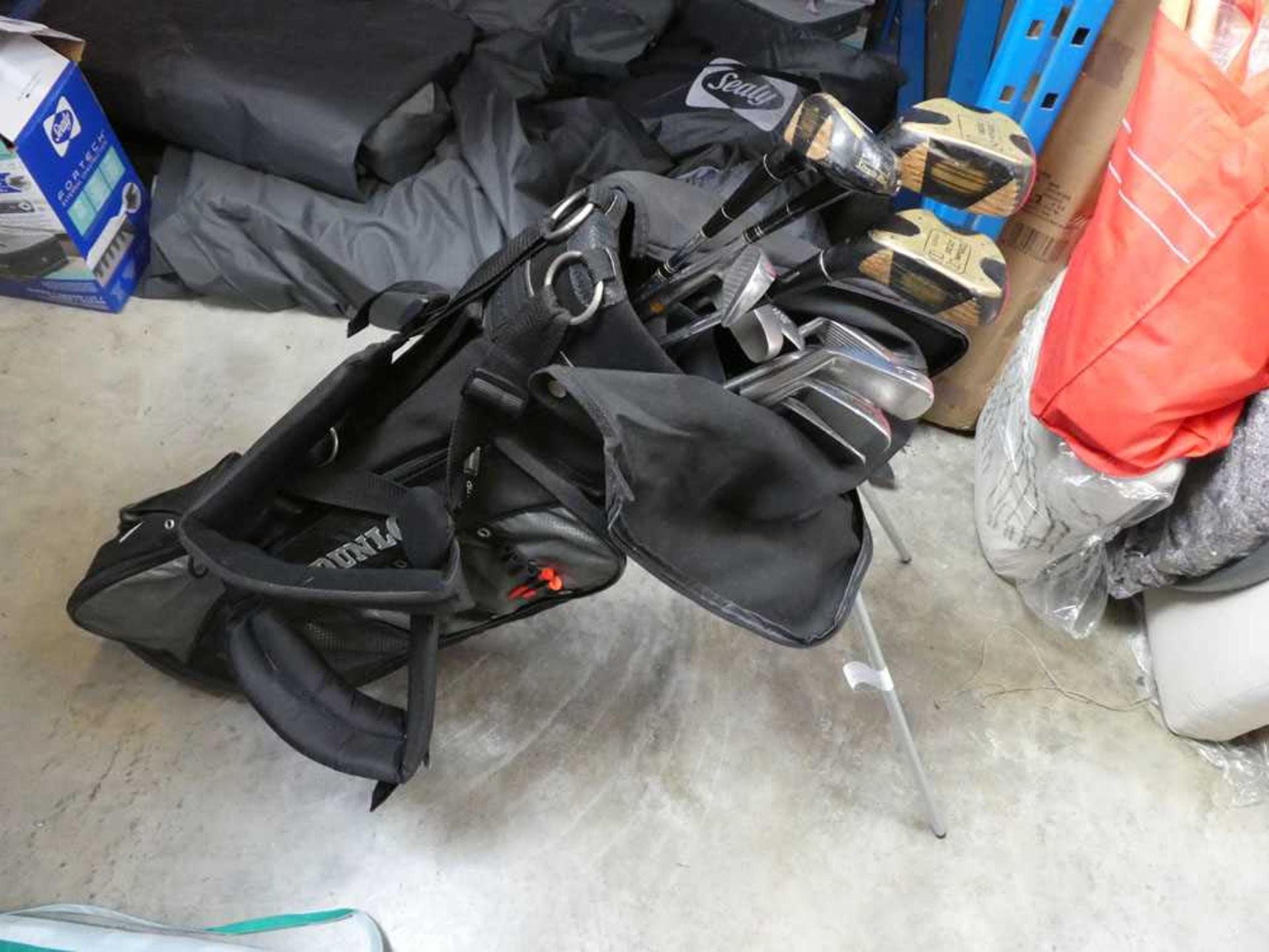 Dunlop golf bag containing mainly Wilson golf clubs, etc.