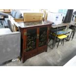 Oriental hard wood cabinet with decorative inset gilt painted panels depicting traditional scenes
