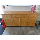 Modern light oak sideboard with 4 cupboards and 4 drawers