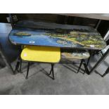 3 similar mid century colourful tables on black tapered supports; 1 yellow and 2 with picture