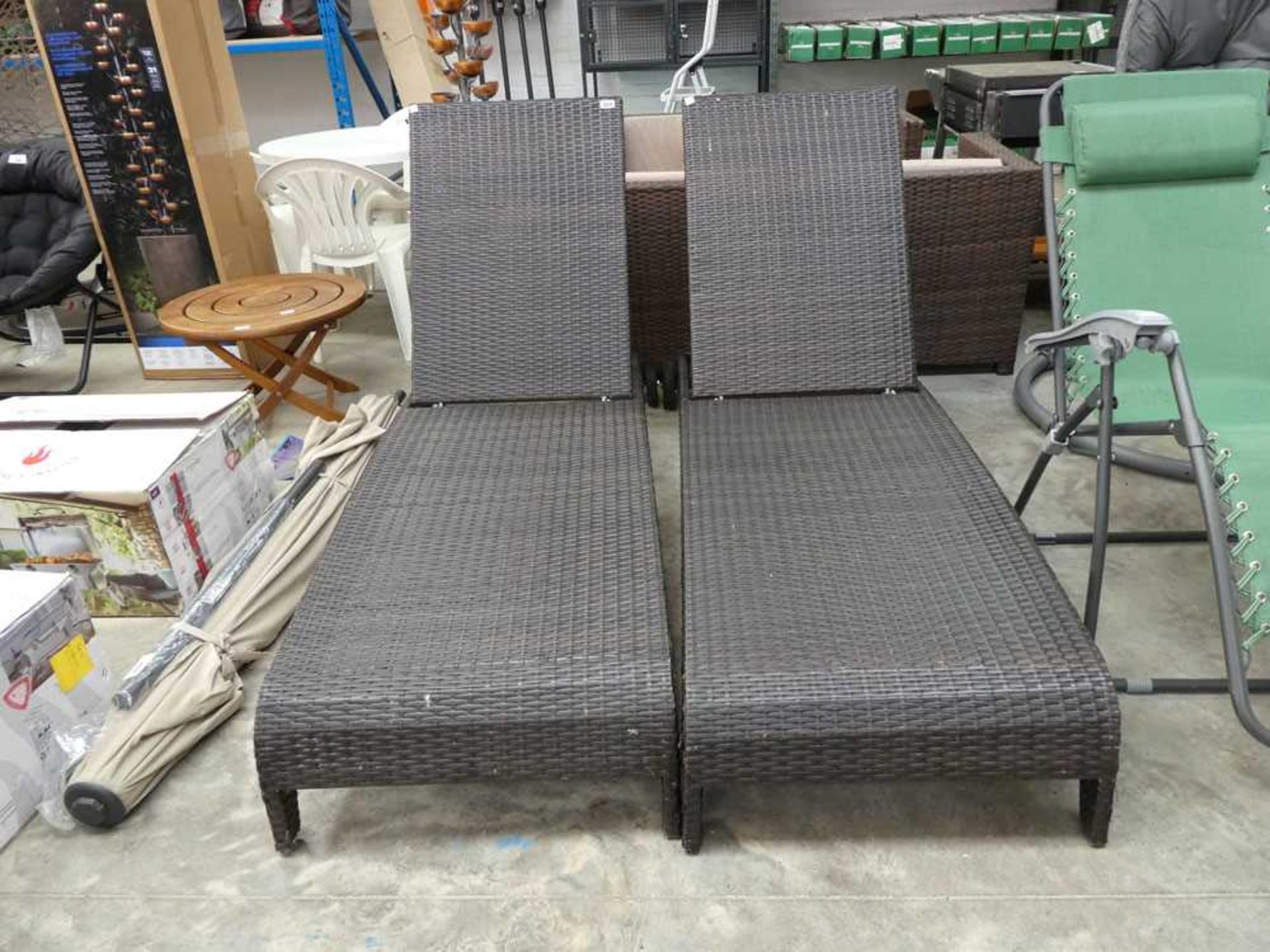 Pair of brown rattan reclining sun loungers