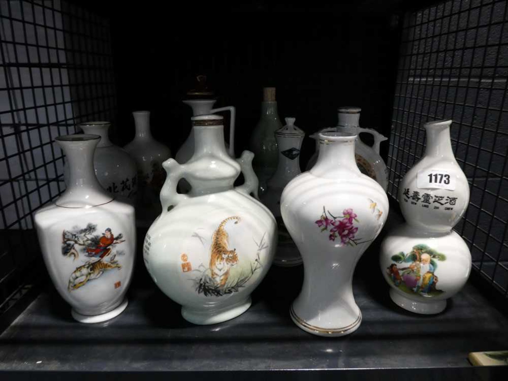 Cage of Oriental vases and liquor bottles