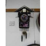 Black cased Elvis Presley themed cuckoo type clock with hourly Elvis hit chime