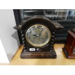 Dark oak cased mantle clock with barley twist detail, the movement stamped 'Junghans Wurttemberg