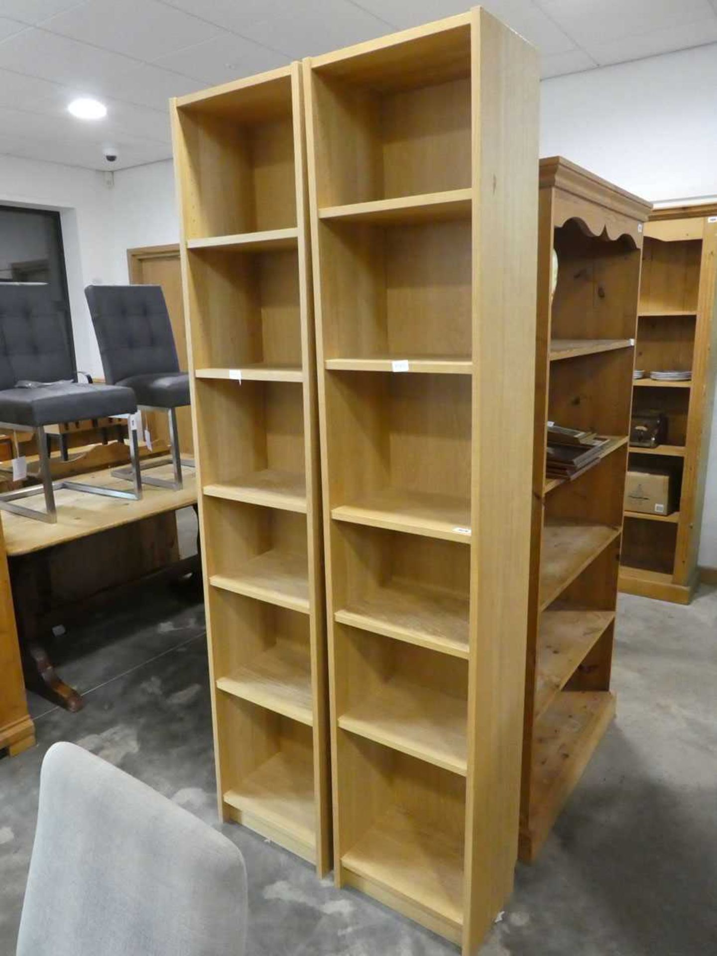 Slim modern pair of light oak finished open fronted bookcases
