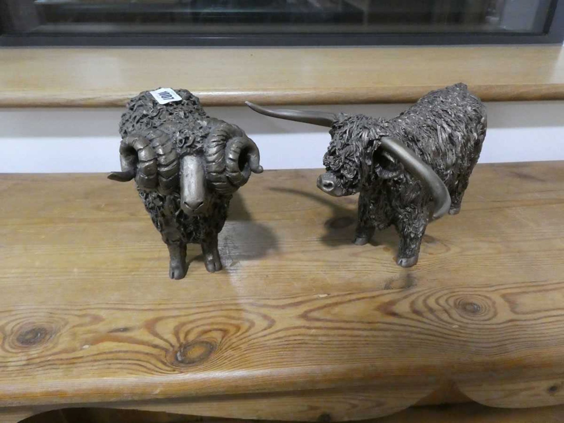 Pair of bronze effect ornaments; highland cow and ram