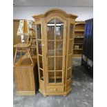 Modern pine faceted glazed display cabinet with single drawer to base