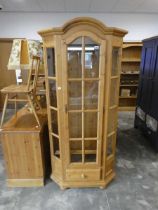 Modern pine faceted glazed display cabinet with single drawer to base