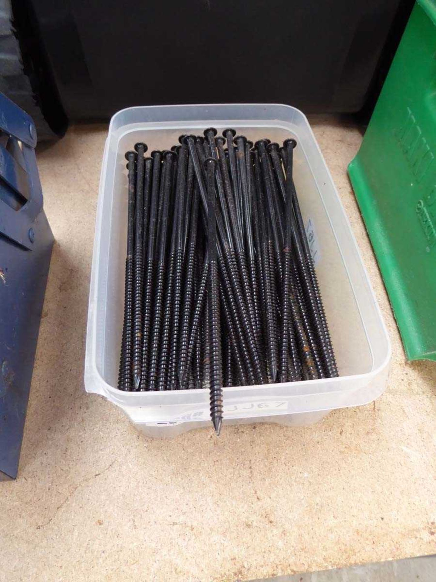 Tub containing 8" long black screws