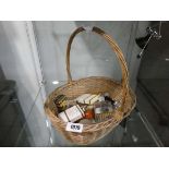 Wicker basket containing a variety of various perfumes. mostly testers