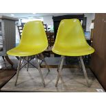 Pair of modern dining chairs with green plastic seats