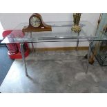 Glass topped metal framed dining table