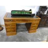 Yew twin pedestal office desk with tooled green leather writing surface