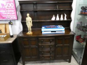 Dark ercol dresser with 4 central drawers and 2 cupboards