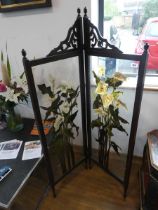 Glass painted two panel folding screen, decorated with lilies within a dark frame surround