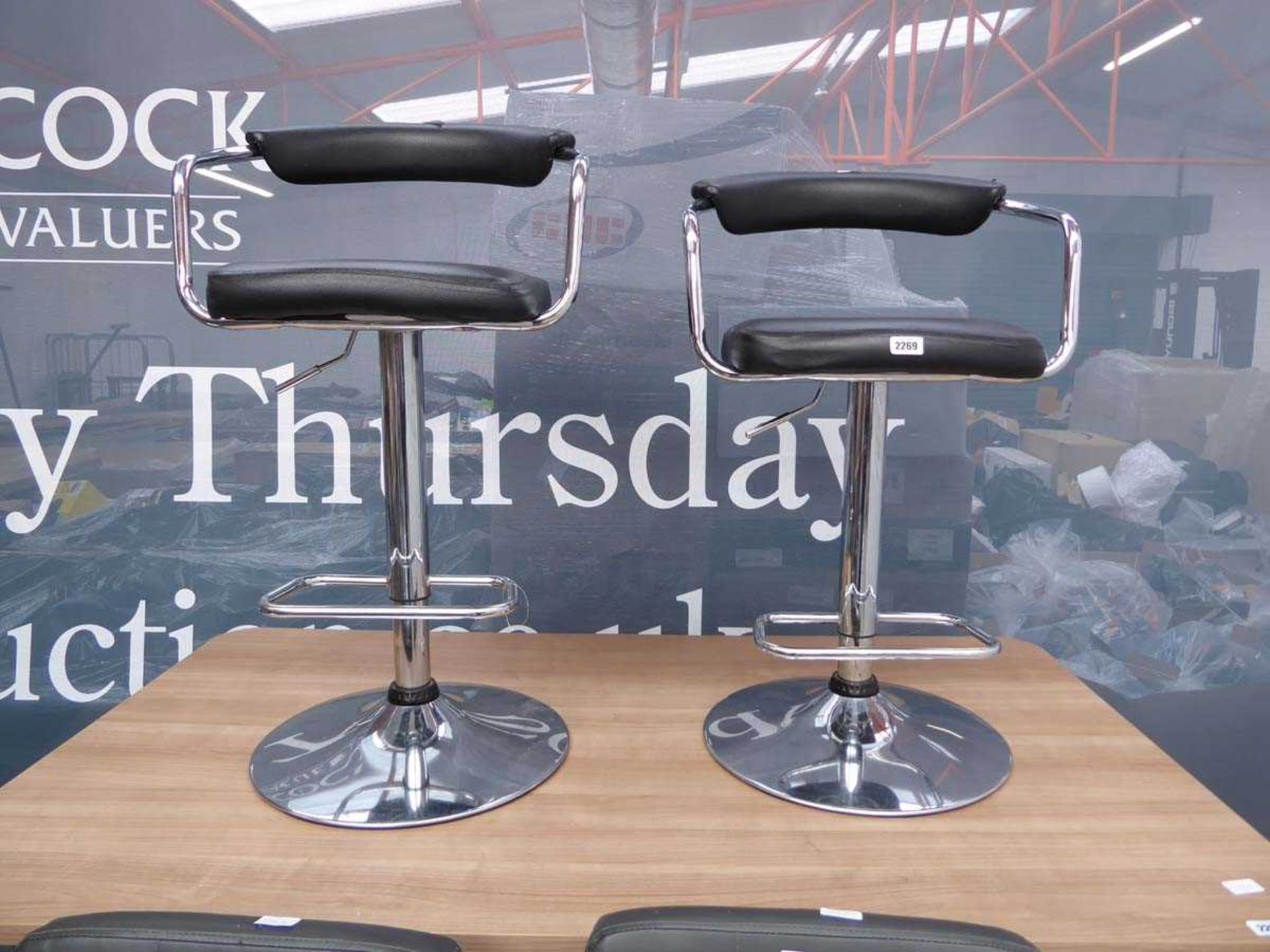 Pair of black leatherette and chrome height adjustable bar stools