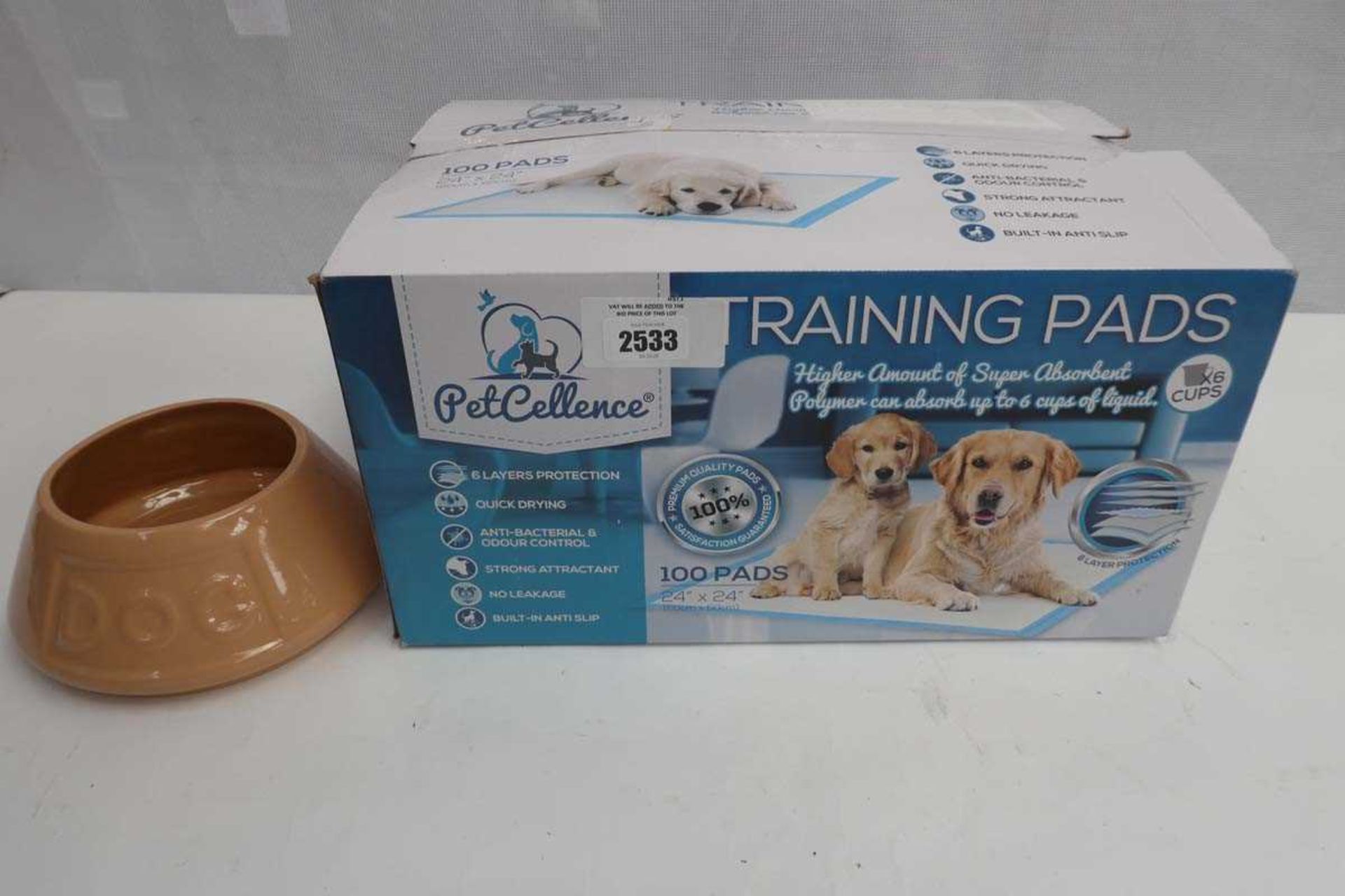 +VAT Puppy training pads, boxed, together with a dog bowl