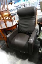 Modern brown leatherette upholstered easy chair with electric powered reclining