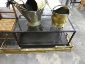 Black metal framed coffee table with glass surface and magazine shelf below