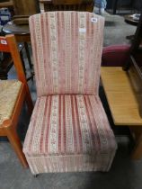 Pink striped upholstered nursing chair with pull out storage section