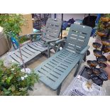 Pair of green plastic garden sun loungers