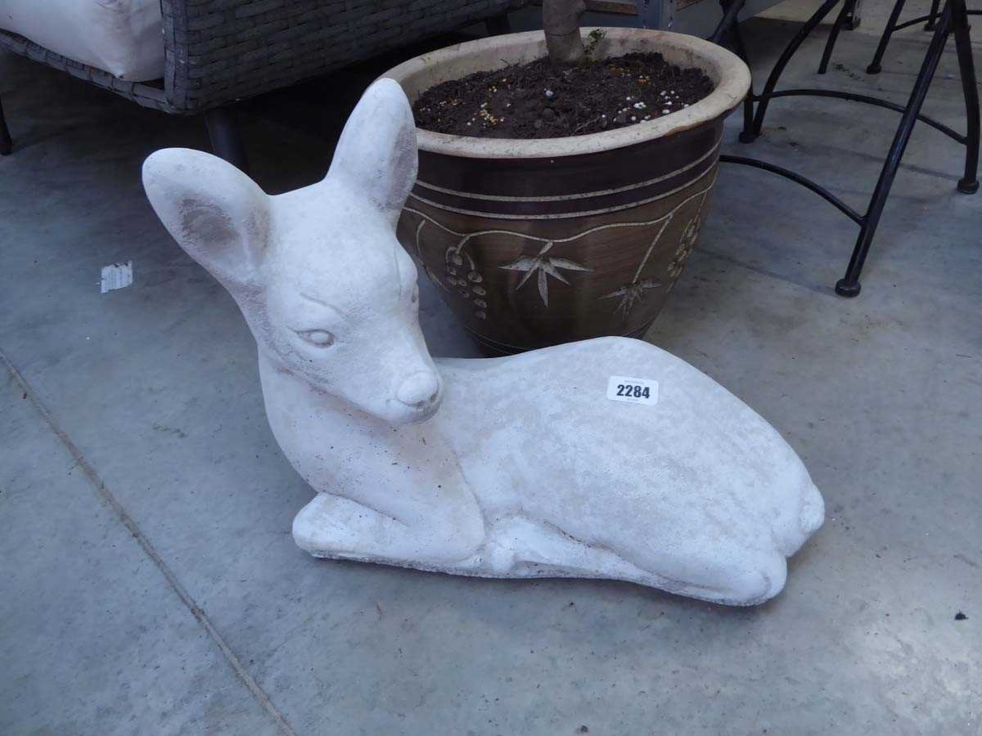 Concrete deer laying down