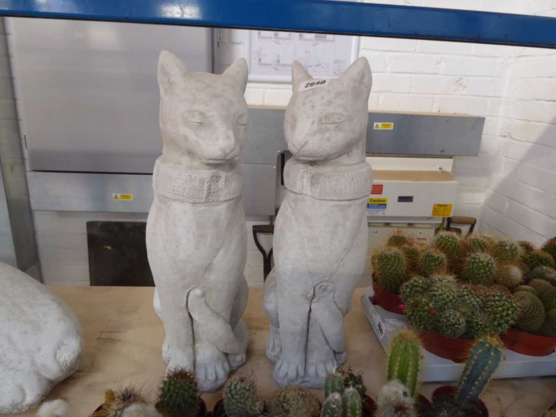 Pair of concrete sitting cats