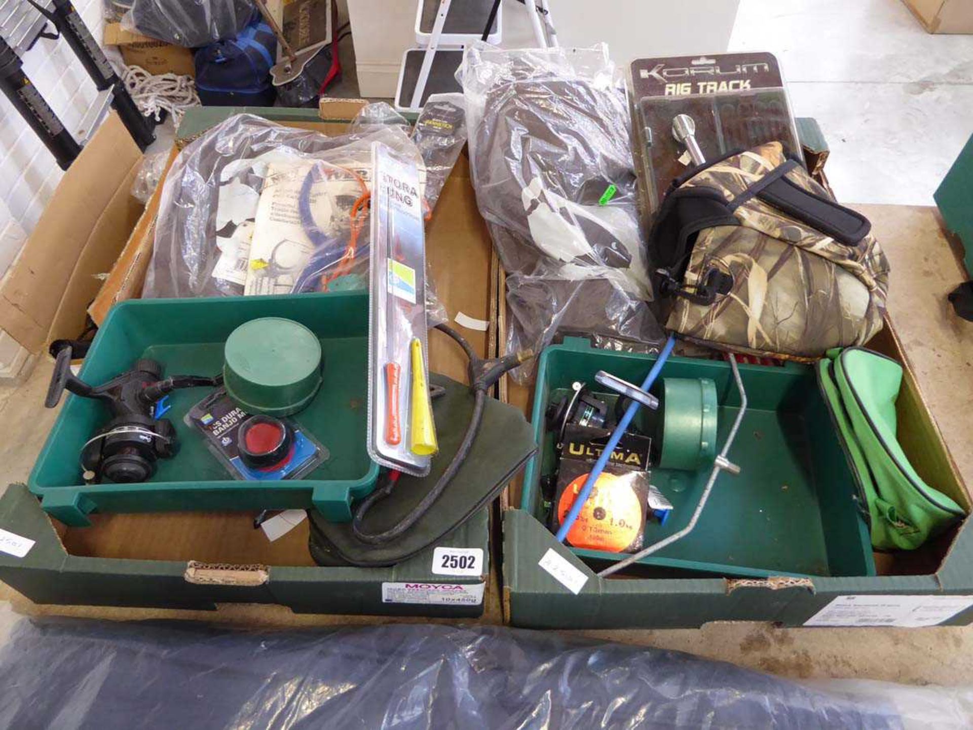 2 crates containing qty of mixed fishing items to include reels, catapult, camouflage bag etc