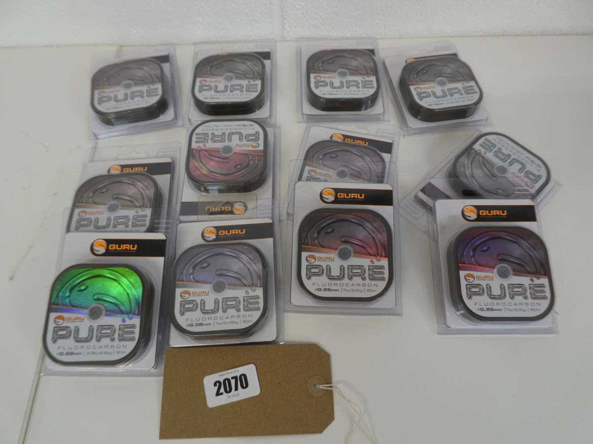 12 packs of Guru Pure fluorocarbon fishing line (various breaking strains from 1-10lb)