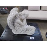 Concrete kneeling angel