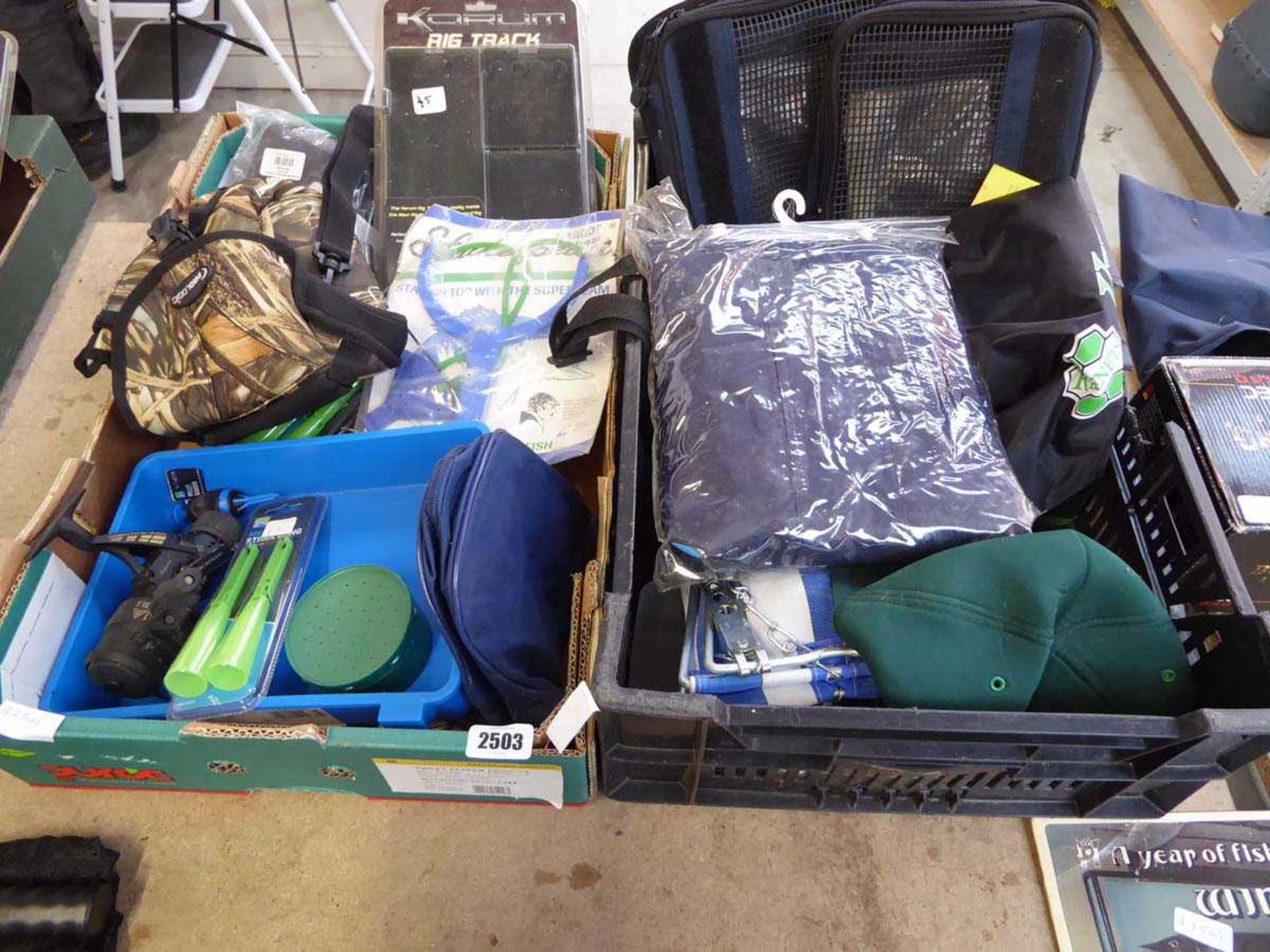 2 crates containing qty of mixed fishing items to include reels, catapult, camouflage bag etc