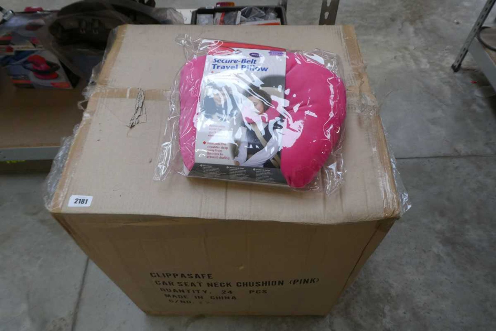 Box containing 24 pink car seat neck cushions